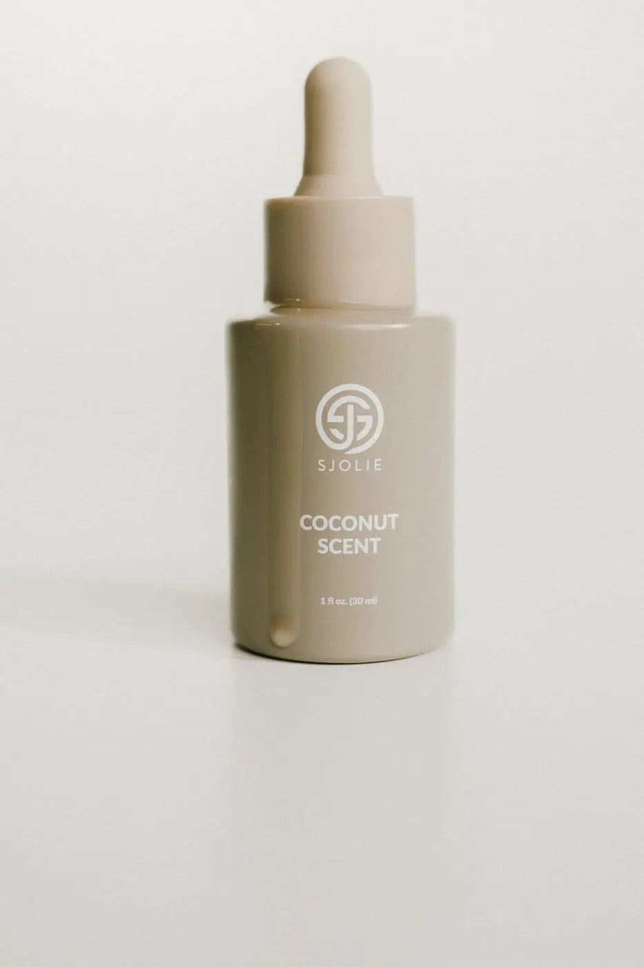 Sjolie Coconut Scent Drops mixed with spray tan solution for a customized tanning experience.